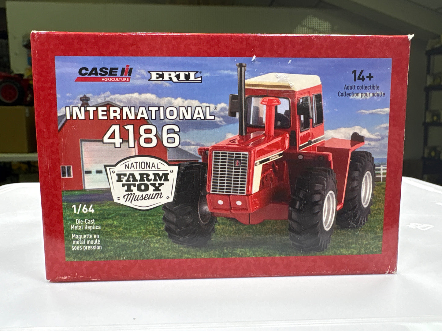 Boxed red tractor model with 'Case International' branding on a white surface.