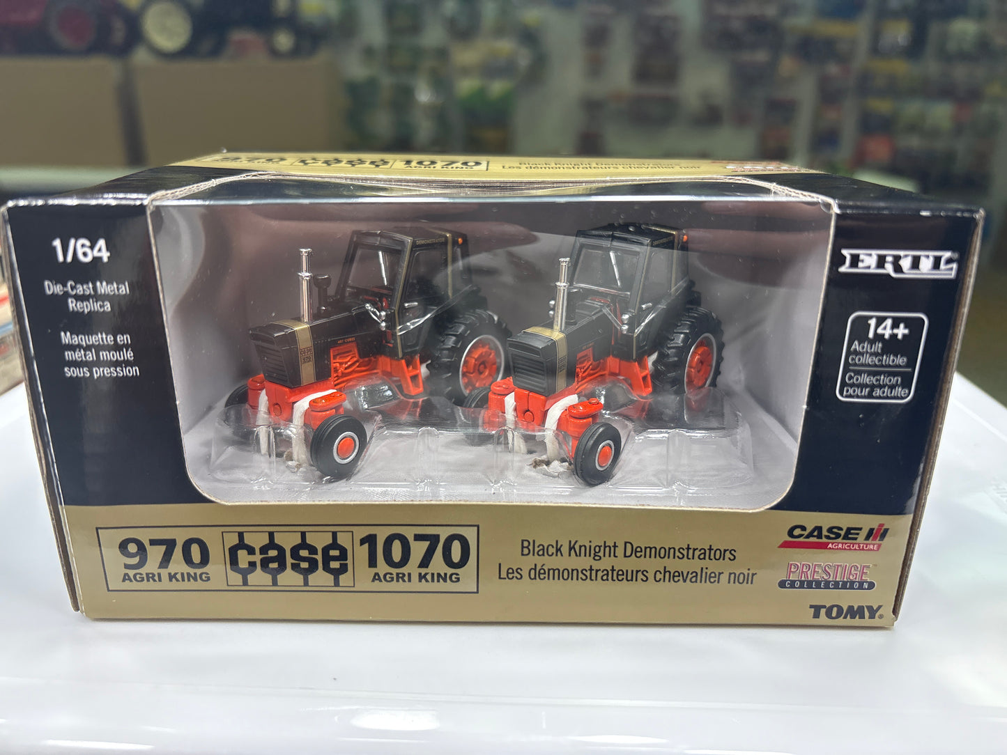 Model tractor set in packaging with visible branding on a blurred background