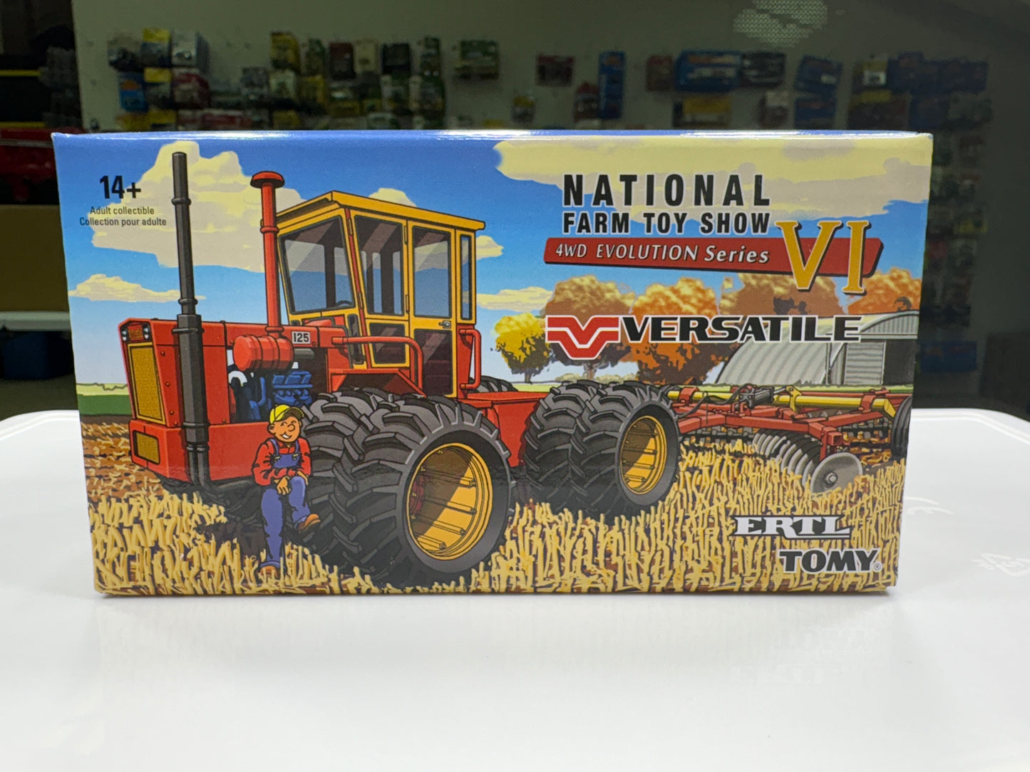 Box for a toy tractor with 'Versatile' branding and 'National Farm Toy Show' text.