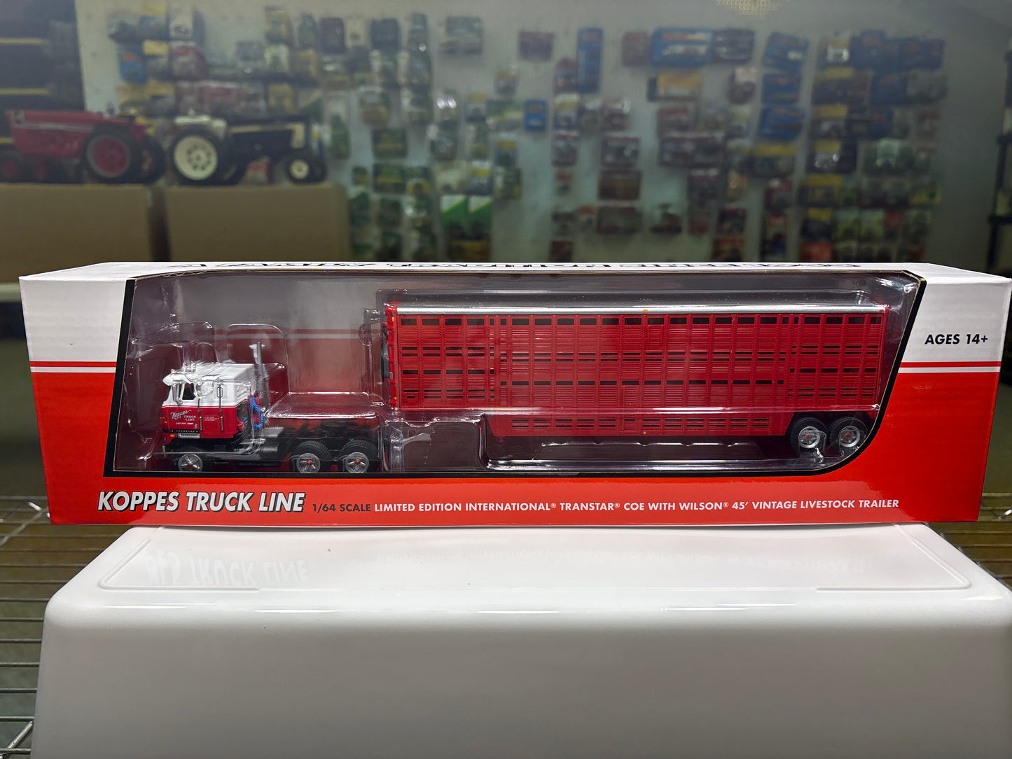 Koppe's Truck Line model truck in packaging with a display of other models in the background.