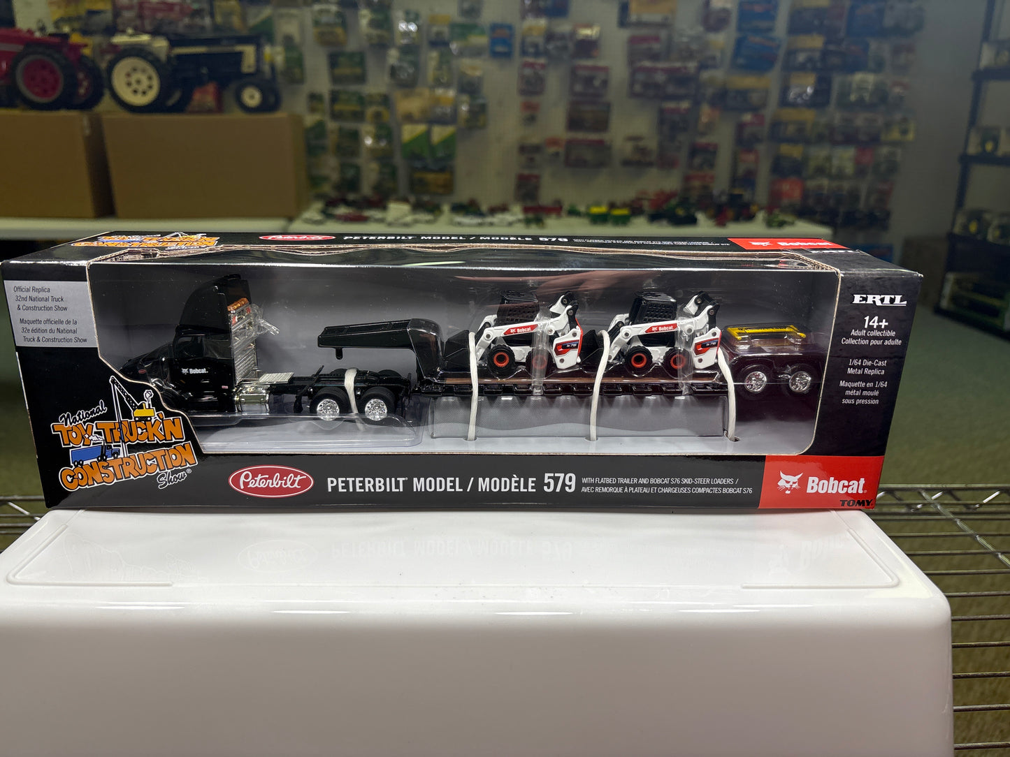 Peterbilt Model 579 with Flatbed Trailer and Bobcat S76 Skid-Steer Loaders