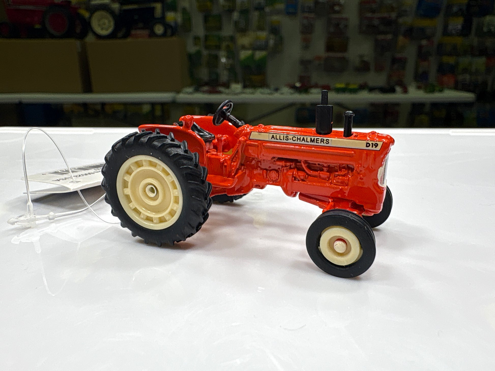 Model tractor on a white surface with a blurred background