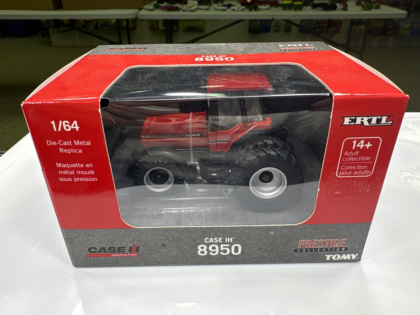 Model tractor in a red and gray box with Ertl branding