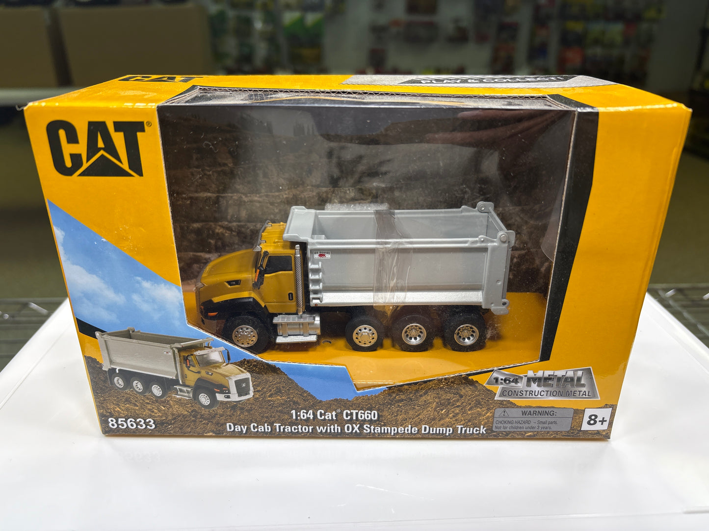 Toy dump truck in packaging with Caterpillar logo