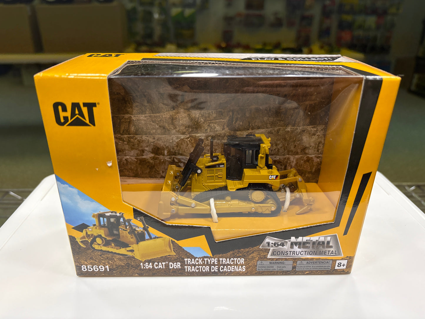 Boxed model of a Caterpillar tractor with clear window