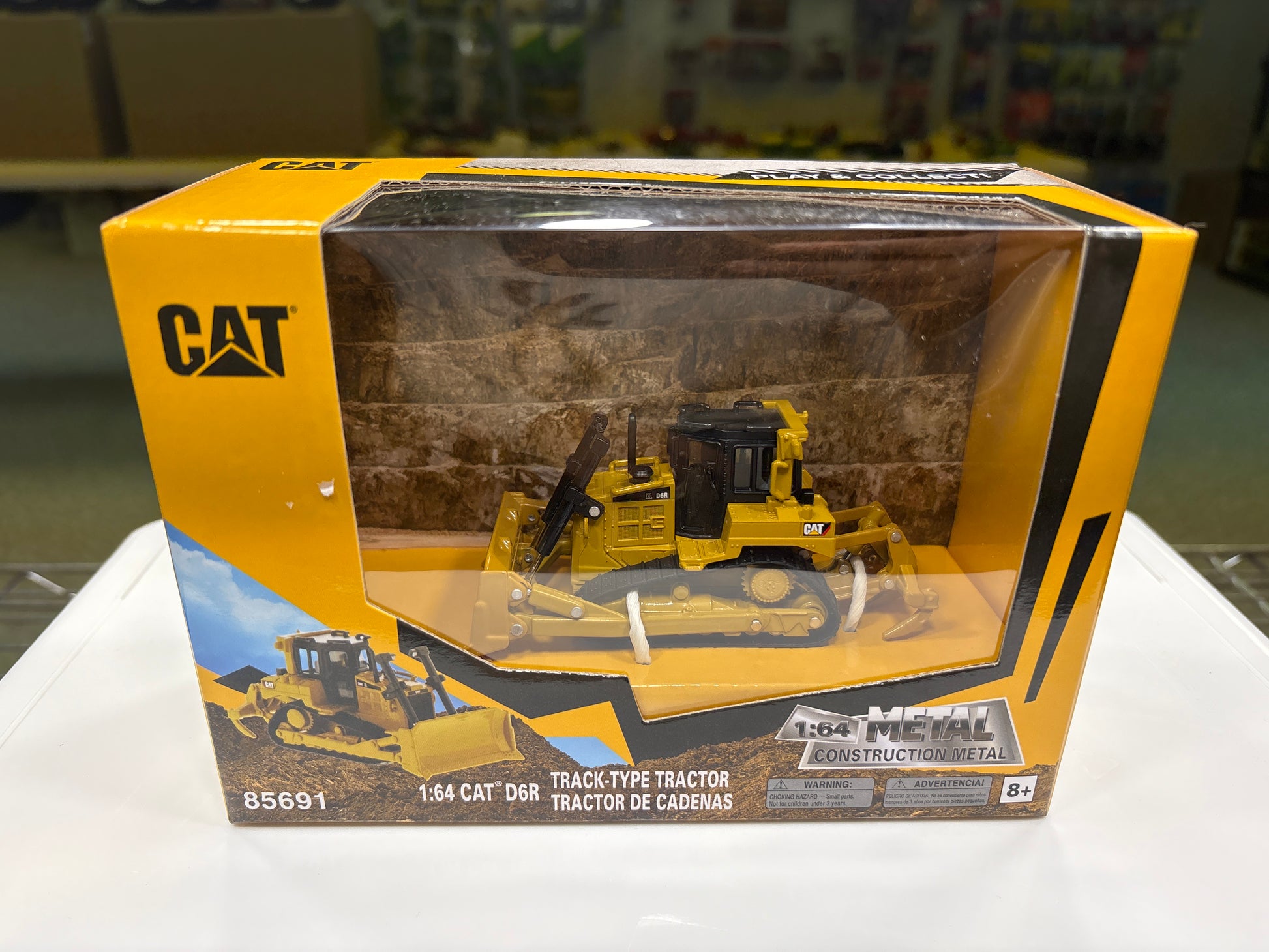 Boxed model of a Caterpillar tractor with clear window