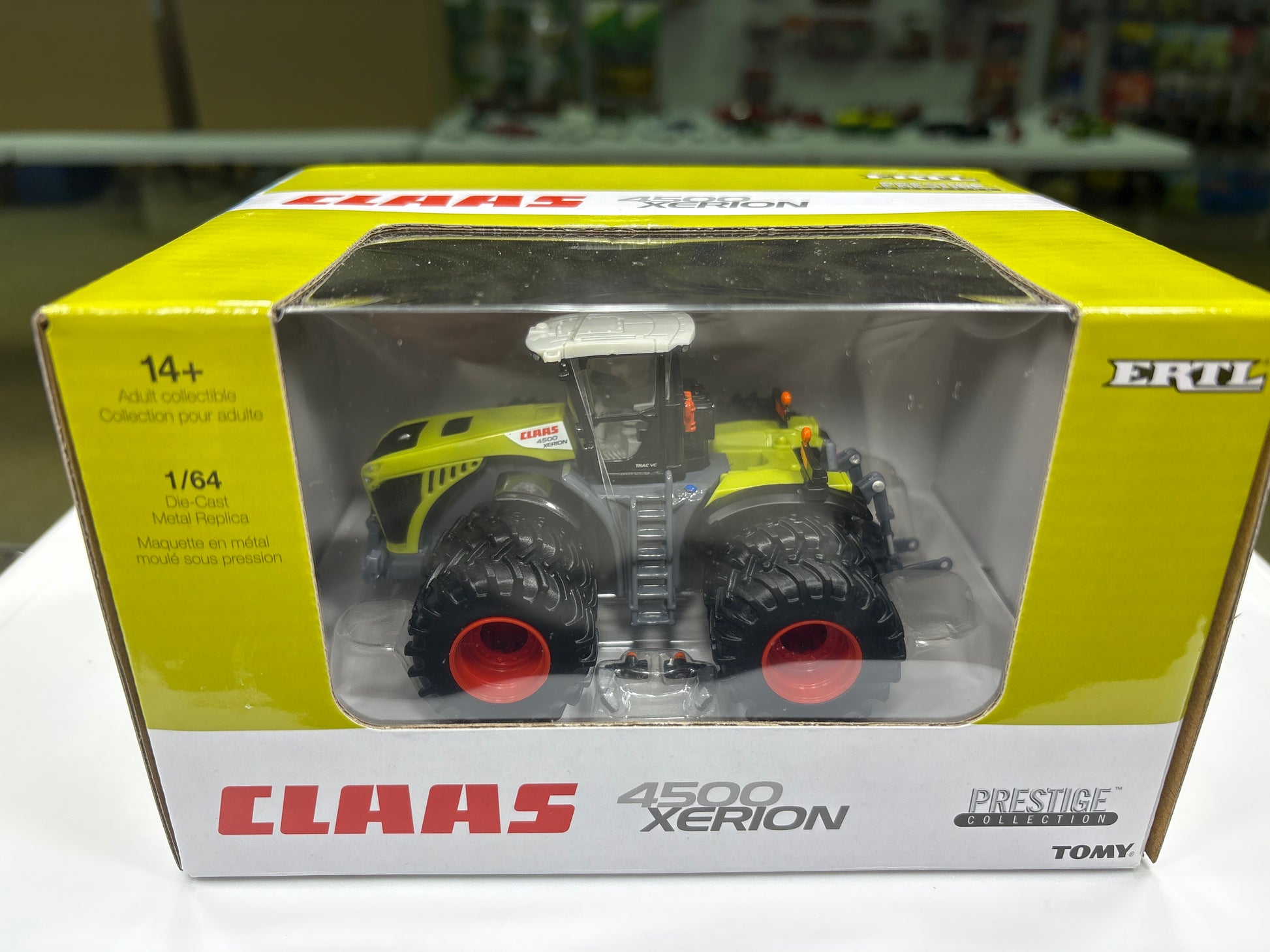 Boxed Claas 4500 Xerion model tractor with ERTL branding on a blurred background.