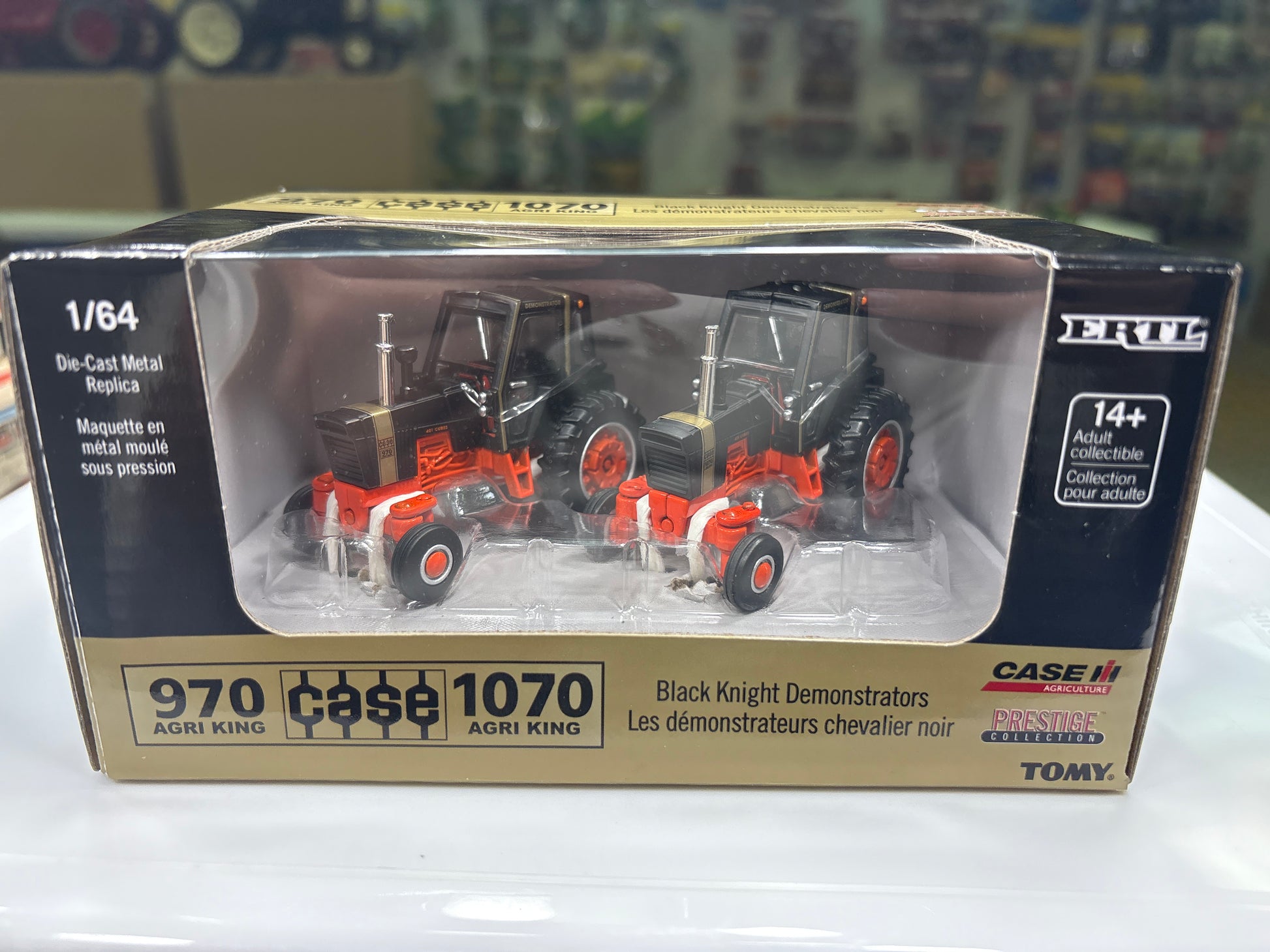 Model tractor set in packaging with visible branding on a blurred background