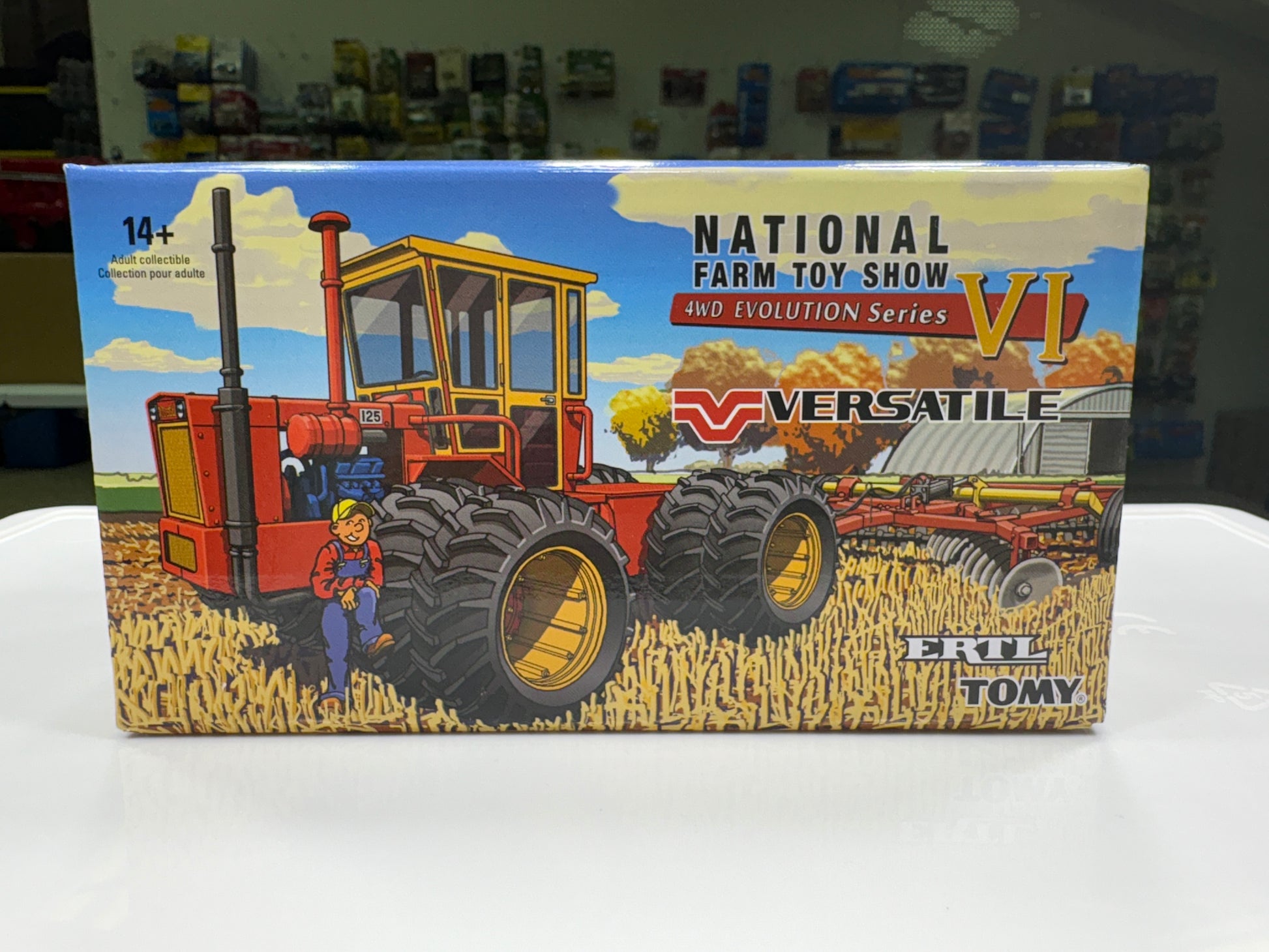 Box for a toy tractor with 'Versatile' branding and 'National Farm Toy Show' text.