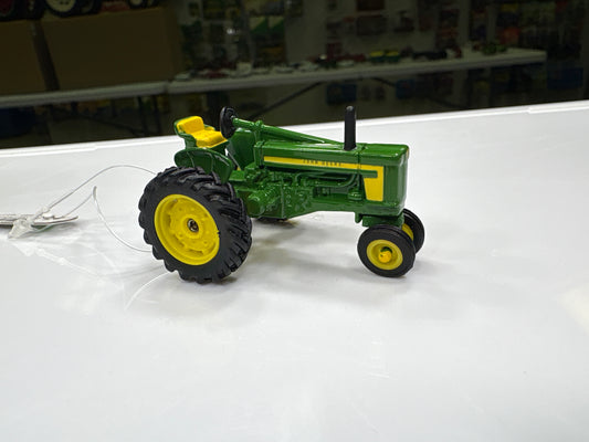 Model tractor on a white surface with a blurred background
