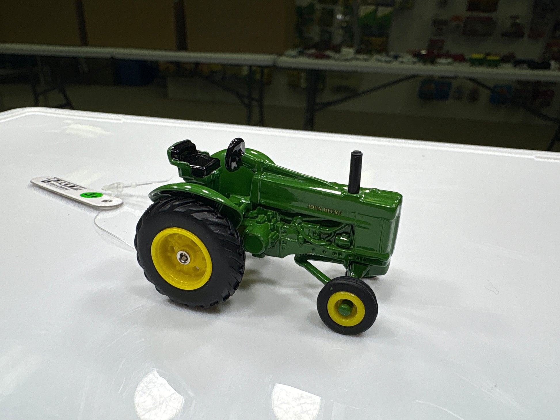 Model tractor on a white surface with a blurred background