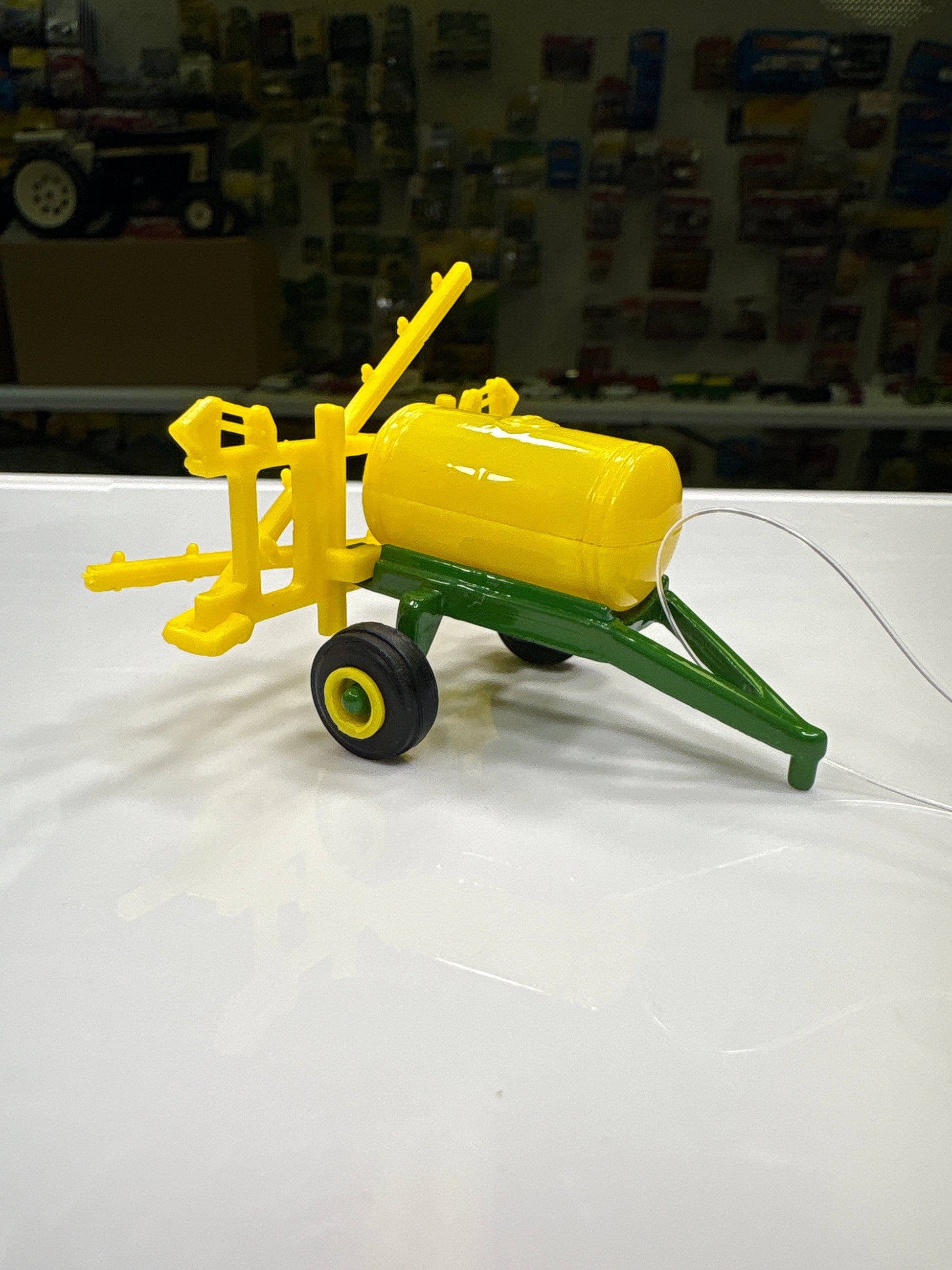 Farm toy on a white surface with a blurred background