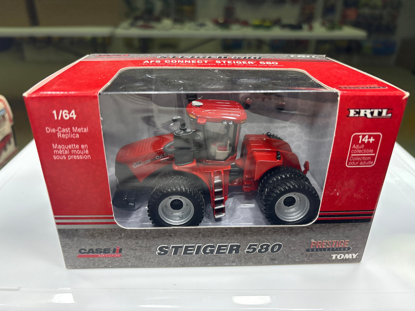 Model tractor in a red and gray box packaging with 'Case IH' branding.