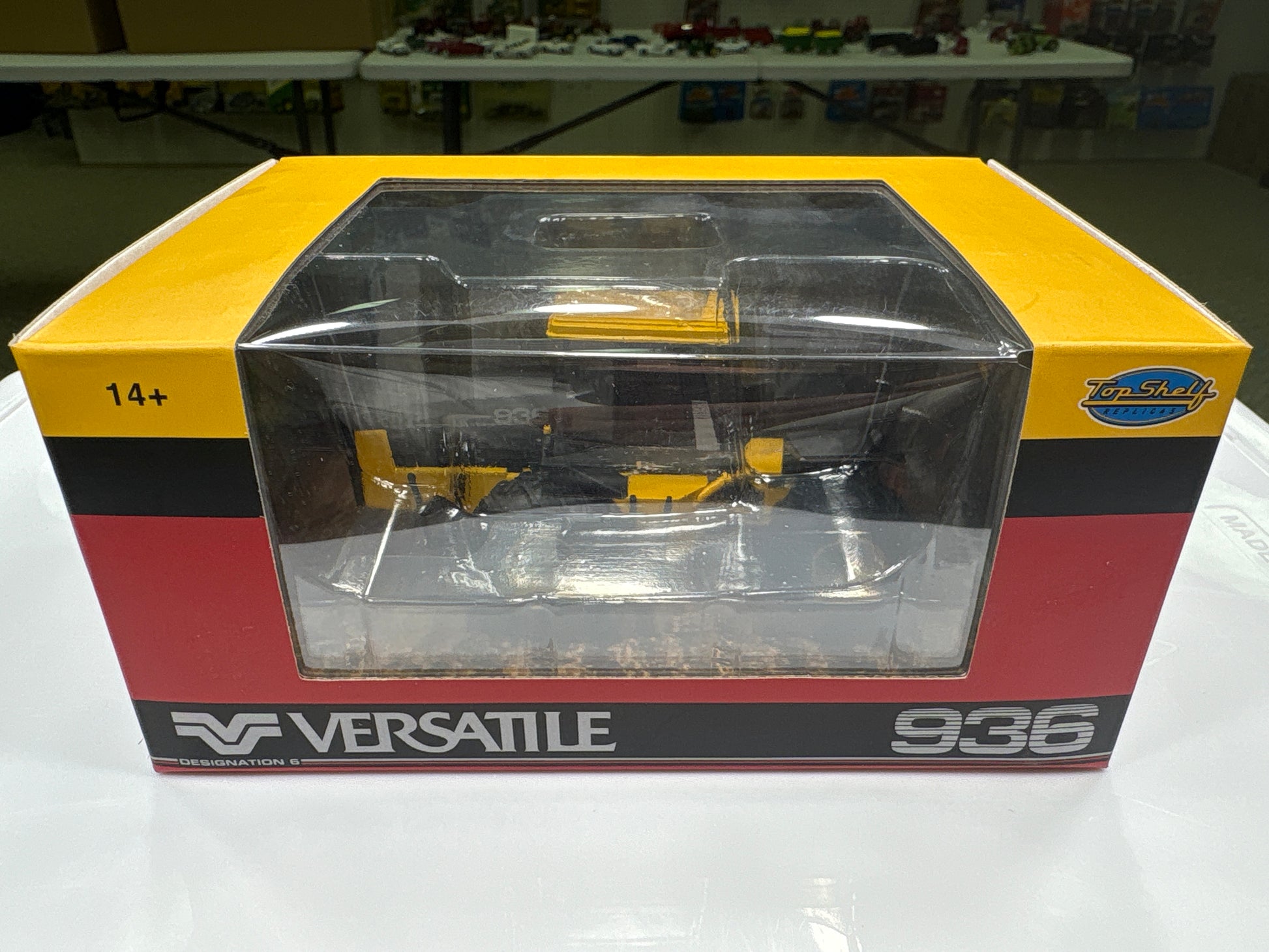 Model tractor in packaging with 'Versatile' branding on a white surface.